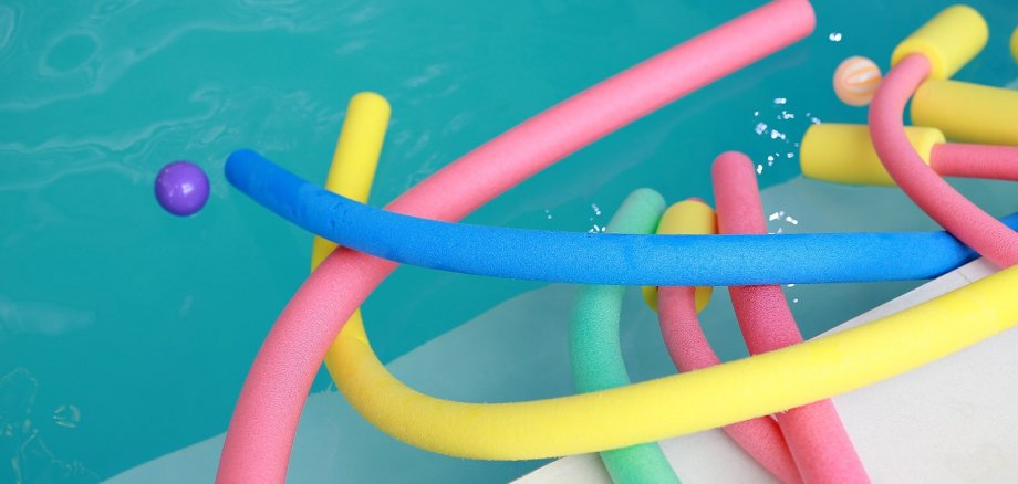water aerobic equipment. colored aqua noodles in swimming pool. water aerobic equipment. colored aqua noodles in swimming pool.
